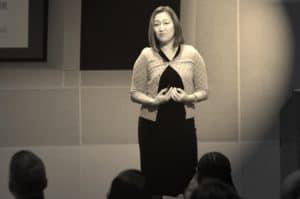 an asian american female executive showing vulnerability during a presentation