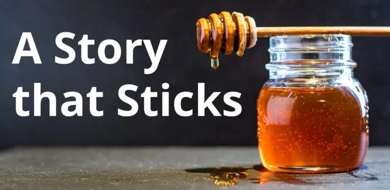 a jar of honey with a honey stick sticking out of it.