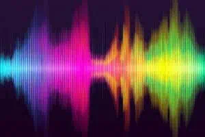 The concept of amplifying voices to boost DEI shown by a colorful sound wave on a black background.