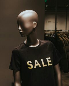 two mannequins with black Sale graphic crew-neck t-shirts