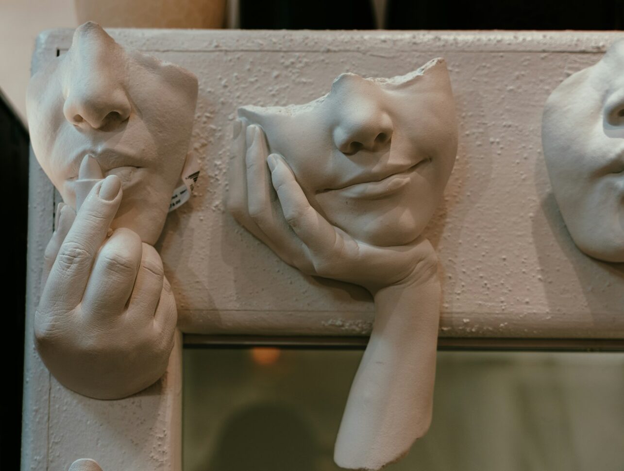 A close up of a couple of masks on a wall