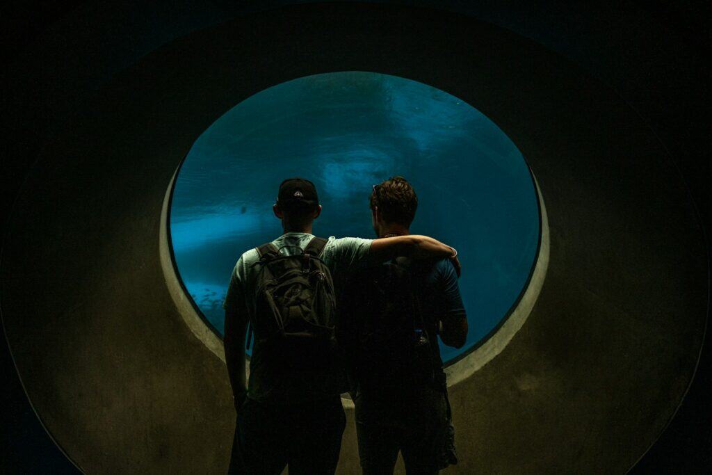 a couple of men looking at a large circular object