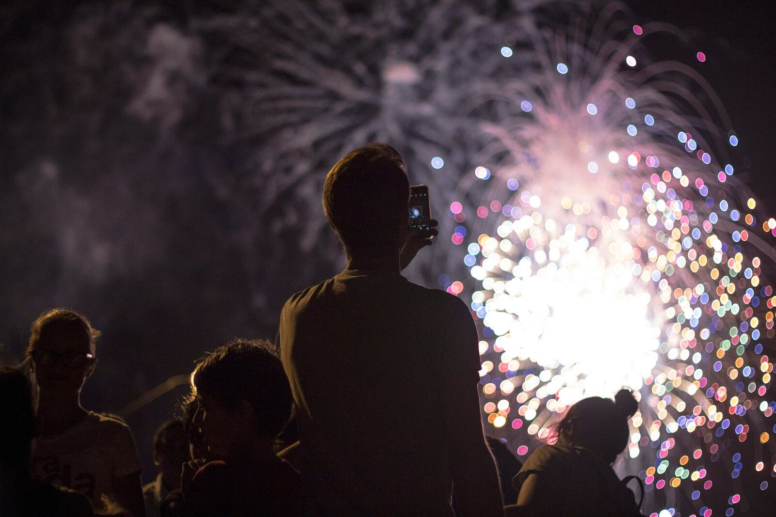 Summer as a Season for Reflection: Stories, Reading, and the Art of Paying Attention 1 man taking picture of firecracker