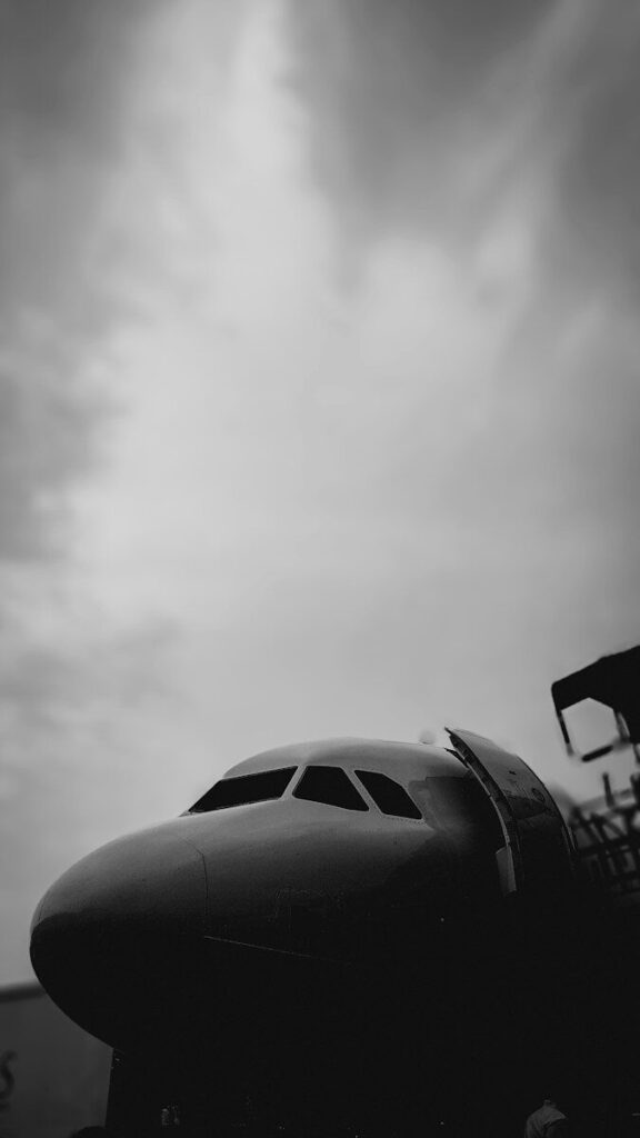 Front view of an airplane cockpit against cloudy sky