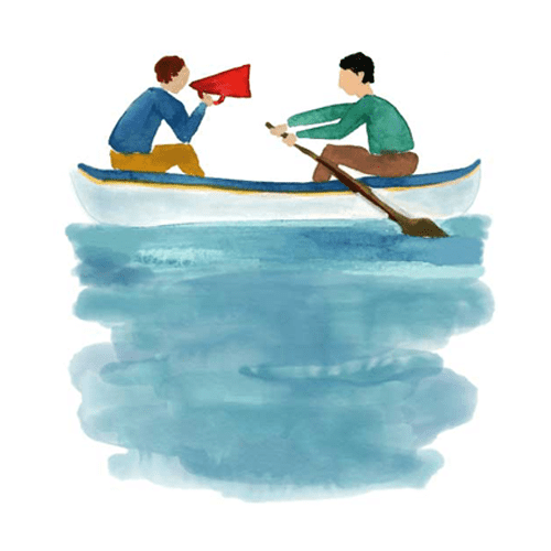 Two people on a boat practicing their storytelling skills with a red bullhorn during a storytelling training.